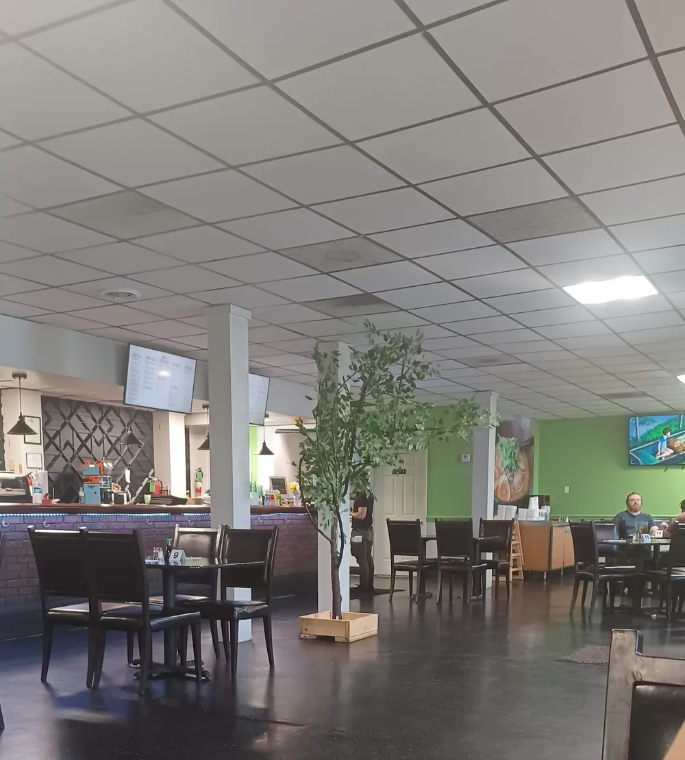 Spacious dining room with bamboo accents and warm lighting inside Kasabi in Hazelwood, MO